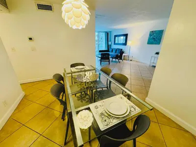 a dining room with a glass table and chairs at Miami Hollywood 2 Bedroom Garden View 001-21mar in Hollywood