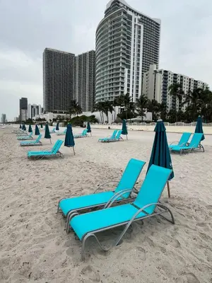 a group of chairs and umbrellas on a beach at Miami Hollywood 2 Bedroom Garden View 001-21mar in Hollywood
