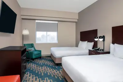 a hotel room with two beds and a television at Four Points by Sheraton Fort Lauderdale Airport - Dania Beach in Dania Beach