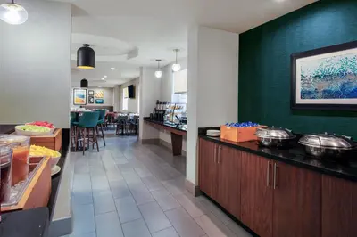 a restaurant with a counter with pots and pans on it at Four Points by Sheraton Fort Lauderdale Airport - Dania Beach in Dania Beach
