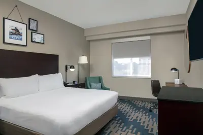 a hotel room with a bed and a desk and a window at Four Points by Sheraton Fort Lauderdale Airport - Dania Beach in Dania Beach