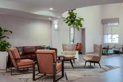 a waiting room with chairs and a couch at Four Points by Sheraton Fort Lauderdale Airport - Dania Beach in Dania Beach