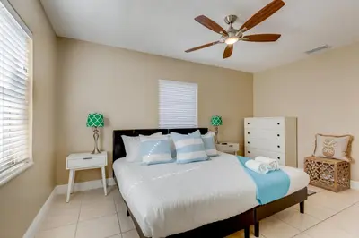 a bedroom with a bed with a ceiling fan at The oasis near the cruise & airport - By Avi in Fort Lauderdale
