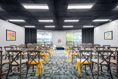 a room with rows of chairs with yellow bows at Quality Inn Miami South in Kendall
