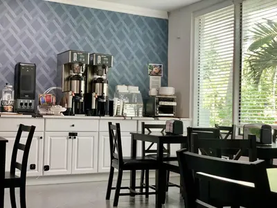 a kitchen with chairs and a table with a coffee maker at Atrium Hotel, Trademark Collection by Wyndham in Miami