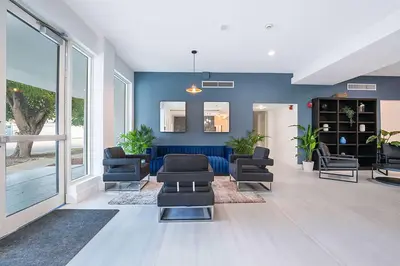 a living room with blue walls and chairs and a couch at Atrium Hotel, Trademark Collection by Wyndham in Miami
