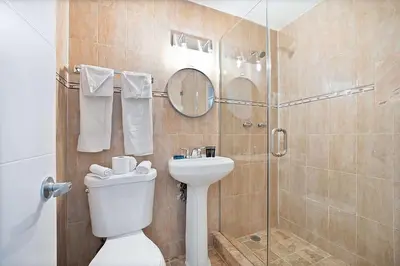 a bathroom with a shower and a toilet and a sink at Atrium Hotel, Trademark Collection by Wyndham in Miami