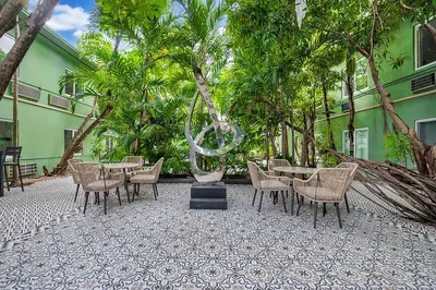 a group of tables and chairs in front of a building at Atrium Hotel, Trademark Collection by Wyndham in Miami