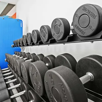 a row of dumbbells in a gym at Hilton Garden Inn Ft. Lauderdale Airport-Cruise Port in Dania Beach