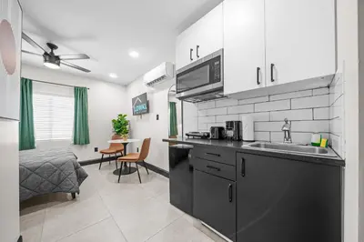 a kitchen with a sink and a counter top at Baybreeze Apartments by Lowkl in Miami Beach