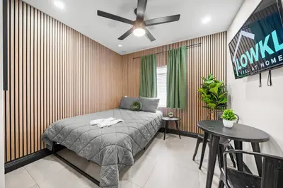 a bedroom with a bed and a table at Baybreeze Apartments by Lowkl in Miami Beach