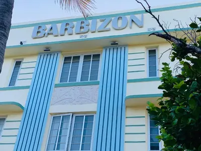 a building with a sign on the side of it at Beach House BEACHFRONT STUDIO 107 in Miami Beach