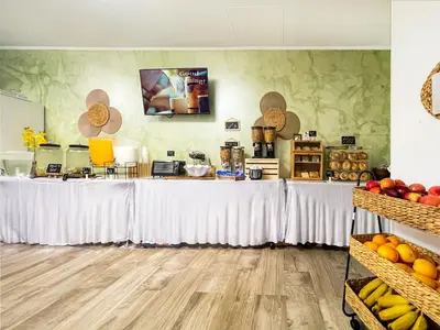 a long table with white curtains and fruit on it at The Palms in Hollywood