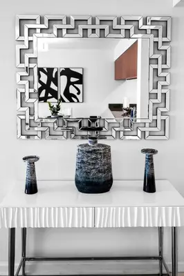a table with two vases on it with a mirror at Luxurious Condo in Brickell with Free Parking in Miami