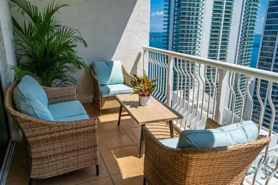 a balcony with chairs and tables on a balcony at Luxurious Condo in Brickell with Free Parking in Miami