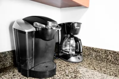 a coffee maker sitting on a counter next to a blender at Luxurious Condo in Brickell with Free Parking in Miami