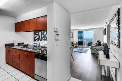 an open kitchen with a view of a living room at Luxurious Condo in Brickell with Free Parking in Miami