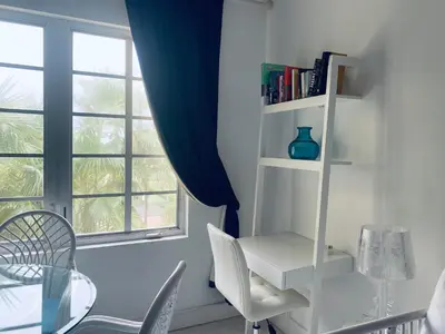 a dining room with a table and chairs and a window at vacation home-ocean view SoBe 318 in Miami Beach