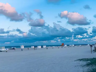 a beach with a cloudy sky and the ocean at Beach house -magic SoBe 209 in Miami Beach