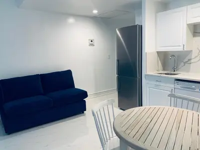 a living room with a blue couch and a table at Beach house -magic SoBe 209 in Miami Beach