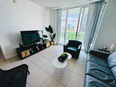 a living room with a couch and a tv at Miami Hollywood Premier two bedroom with bay view 002-22bvic in Hollywood