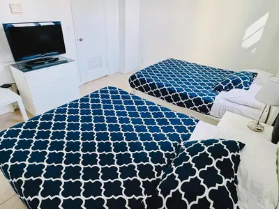 a bedroom with two beds and a tv in it at Miami Hollywood Premier two bedroom with bay view 002-22bvic in Hollywood