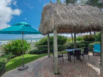 a patio with a table and a straw umbrella at Miami Hollywood Premier two bedroom with bay view 002-22bvic in Hollywood