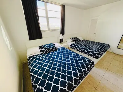 a bedroom with two beds with blue and white comforter at Miami Hollywood Premier two bedroom with bay view 002-22bvic in Hollywood