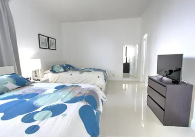 a bedroom with two beds and a flat screen tv at Miami Hollywood Two Bedroom Penthouse With Intracoastal View 005-22bvic in Hollywood