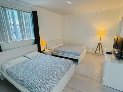 a bedroom with two beds and a television in it at Miami Hollywood Great Two Bedroom Apartment with Channel View 006-22bvic in Hollywood