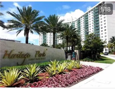 a sign in front of a large building with palm trees at Miami Sunny Isles ocean reserve 704 in Miami