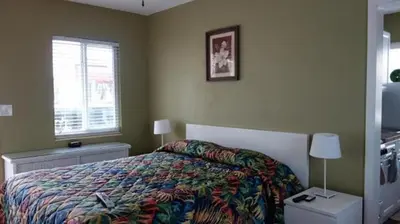 a bedroom with a bed with a colorful blanket and a window at Ocean Drive Villas in Hollywood