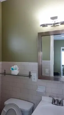 a bathroom with a sink and a toilet and a mirror at Ocean Drive Villas in Hollywood