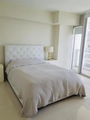 a white bedroom with a large bed and a window at Iconbrickell in Miami