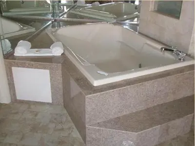 a bath tub in a bathroom with a mirror at Miami Princess Hotel in Miami