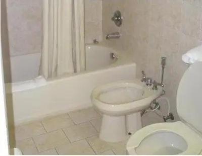 a bathroom with a toilet and a tub and a sink at Miami Princess Hotel in Miami