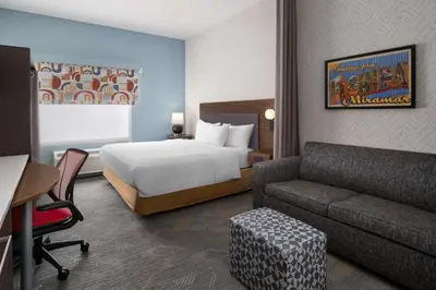 a hotel room with a bed and a couch at Home2 Suites by Hilton Miramar Ft. Lauderdale in Miramar