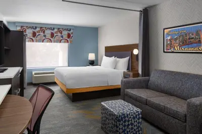 a hotel room with a bed and a couch at Home2 Suites by Hilton Miramar Ft. Lauderdale in Miramar
