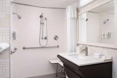 a white bathroom with a sink and a shower at Home2 Suites by Hilton Miramar Ft. Lauderdale in Miramar