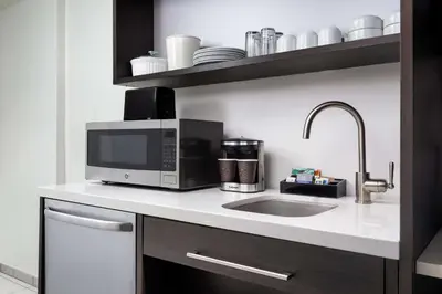 a kitchen with a microwave and a sink at Home2 Suites by Hilton Miramar Ft. Lauderdale in Miramar