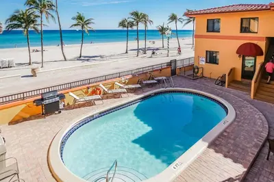 a swimming pool with the beach in the background at Hollywood Sands Resort in Hollywood