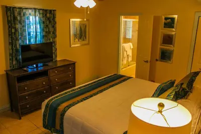 a bedroom with a bed and a television and a dresser at Hollywood Sands Resort in Hollywood