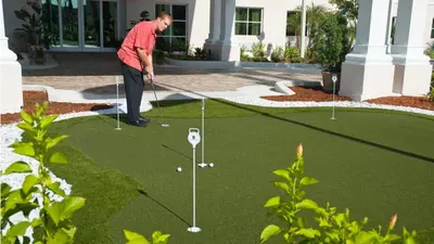 a man playing golf on a putting green at Holiday Inn Express & Suites Miami Kendall by IHG in Kendall