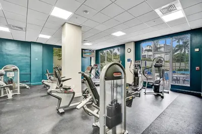 a gym with several tread machines in a room at Luxury Beachfront Apartments 4001 S Ocean Dr in Hollywood
