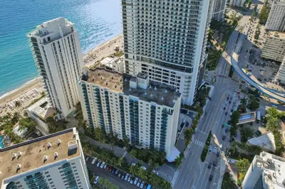 an aerial view of tall buildings next to the ocean at Luxury Beachfront Apartments 4001 S Ocean Dr in Hollywood