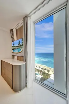 a room with a large window with a view of the ocean at Luxury Beachfront Apartments 4001 S Ocean Dr in Hollywood