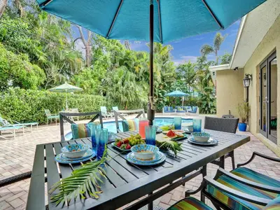 a table with food on it with an umbrella at Vidal Manor in Fort Lauderdale