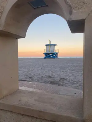 a view of the ocean through an archway at St Maurice Beach Inn in Hollywood