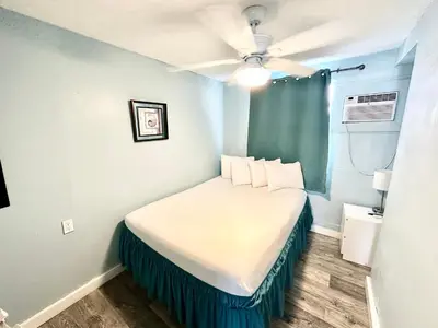 a small bedroom with a bed in a room at St Maurice Beach Inn in Hollywood