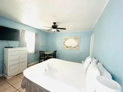 a bedroom with a white bed and a ceiling fan at St Maurice Beach Inn in Hollywood